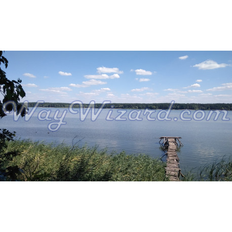 Картина «Тиша біля містка» — старий дерев'яний пірс над тихою річкою під блакитним небом